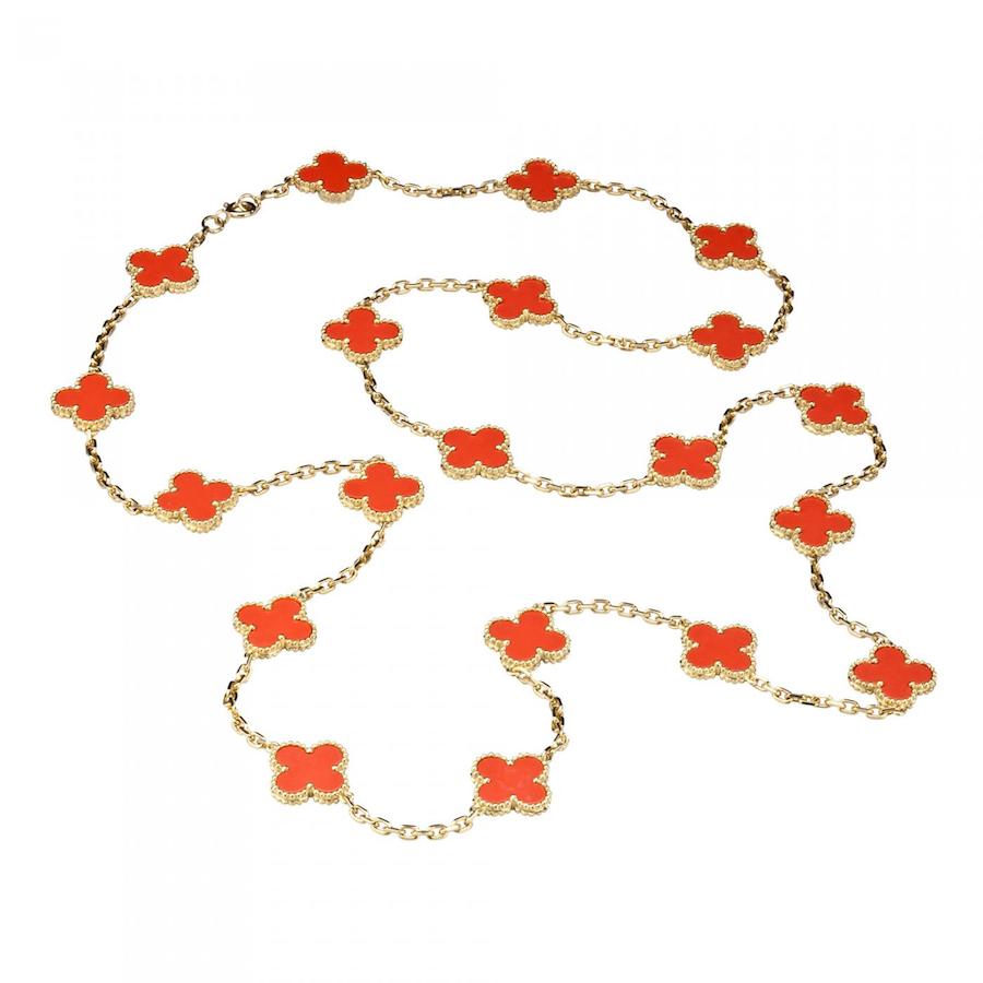 A rare vintage Van Cleef & Arpels gold and coral Alhambra necklace with 20 motifs, circa 1987. Each coral clover is set in a beaded gold bezel. Offered by Leah Gordon
