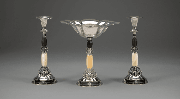 Fig. 1: Console set, Erik Magnussen (1884–1961), designer, 1927. Sterling silver and ivory. Yale University Art Gallery, New Haven, Conn. (compote) Mabel Brady Garvan Collection, by exchange (2002.34.1); (candlesticks) purchased with a gift from Jacqueline Lowe Fowler and the John P. Axelrod, B.A. 1968, Fund (2012.61.1.1-.2).