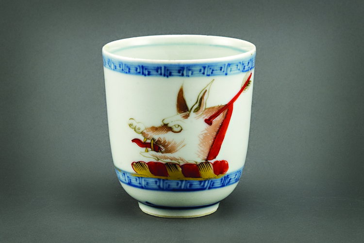 Fig. 7: Coffee cup, China, about 1710. Porcelain. H. 2¾ inches. Gift of H.F. Lenfest and Beverly M. DuBose III. Photography by Kevin Remington. This cup is part of a set made for Harry Gough, who made his fortune from the China Trade. He began his career as a cabin boy at the age of eleven, and by 1707 he was captain of his own ship. The profits from his voyages allowed him to retire from the sea. As part of his program to establish himself as a member of the gentry, Gough commissioned several sets of armorial porcelain.