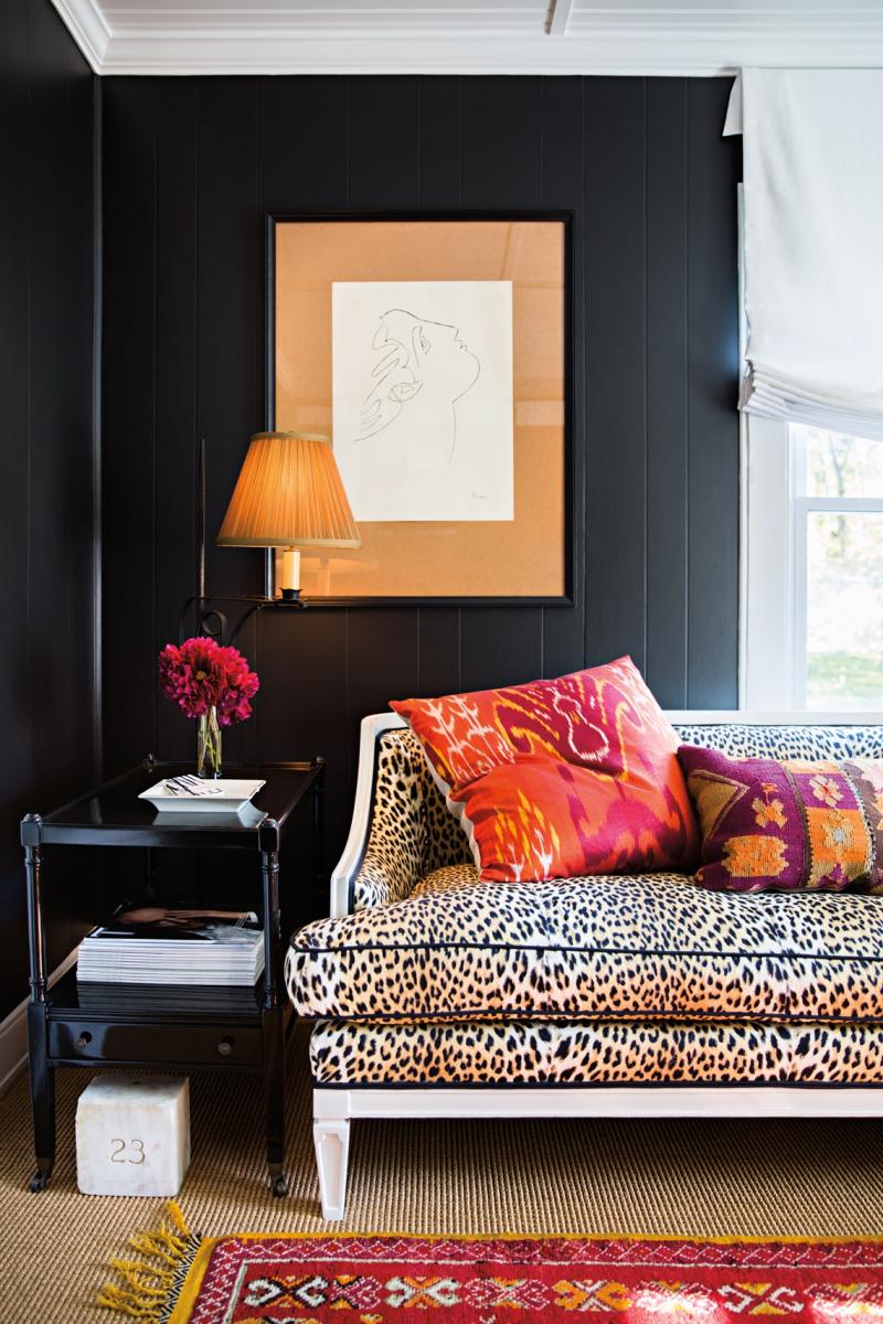 A charcoal wall rhymes with the spots of a leopard pattern.