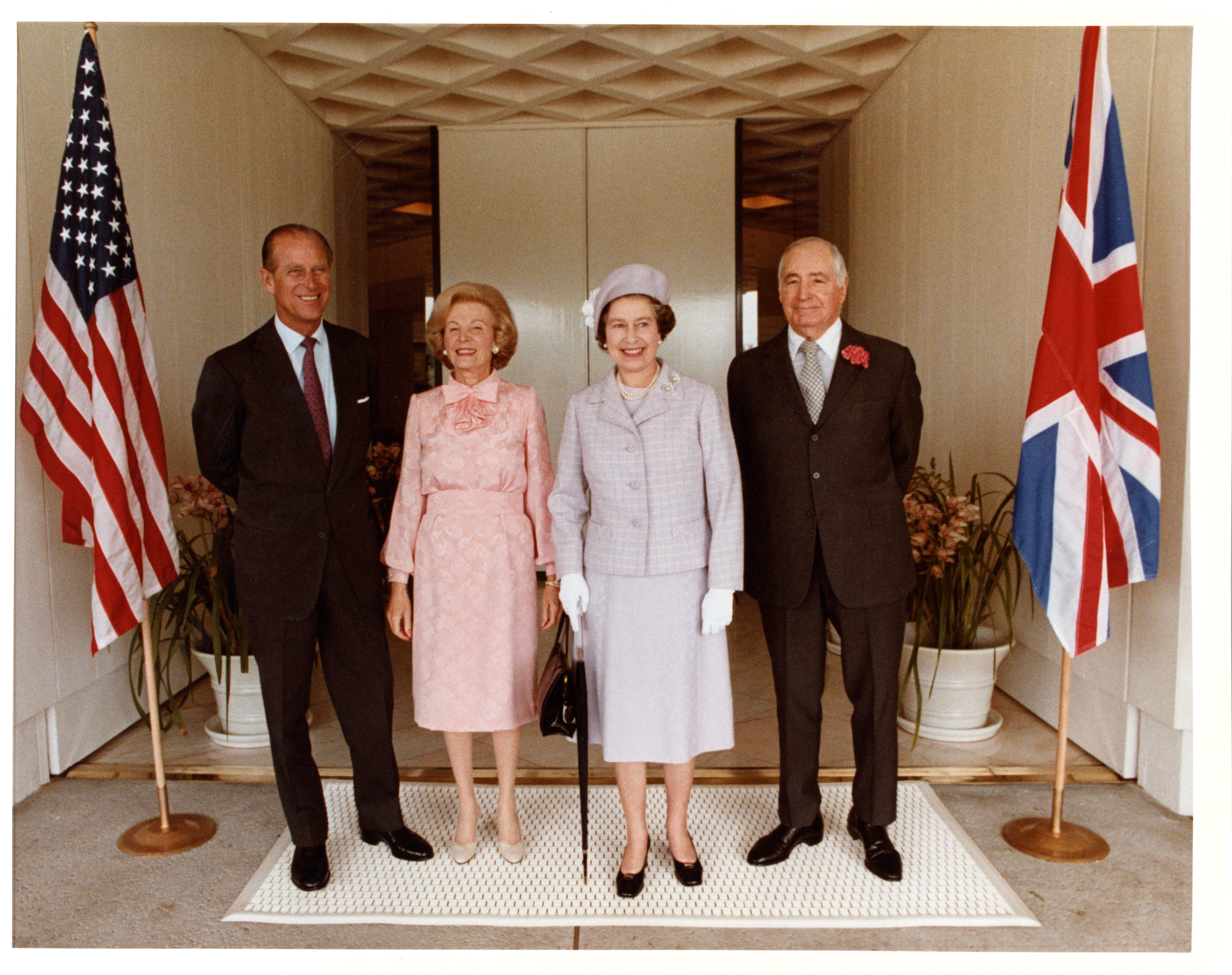 L to R: Prince Phillip, Lee Annenberg, Queen Elizabeth, and Walter Annenberg standing in front of the entrance to the estate house during the Queen’s visit in February 1983. ©The Annenberg Foundation Trust at Sunnylands.
