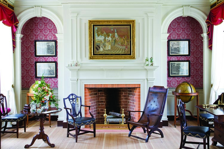 The celestial (1799) and terrestrial (1815) globes in the alcoves were made in London by J. W. Cary. The circa-1830 Campeche armchair’s elegant lines and comfortable form is a favorite of Nick Schorsch’s. Mahogany shield-back chairs have a Greek krater in the center and bell-flower garlands, and are part of a circa-1810 Rhode Island set. The needlework embroidery, titled Queen Esther, is silk-on-silk with silver thread against a watercolor background. The scene portrays an Old Testament theme on the virtuous Esther standing up to King Ahasueras. The black painted surround is titled, A. C. Hotz, Queen Esther, 1820.