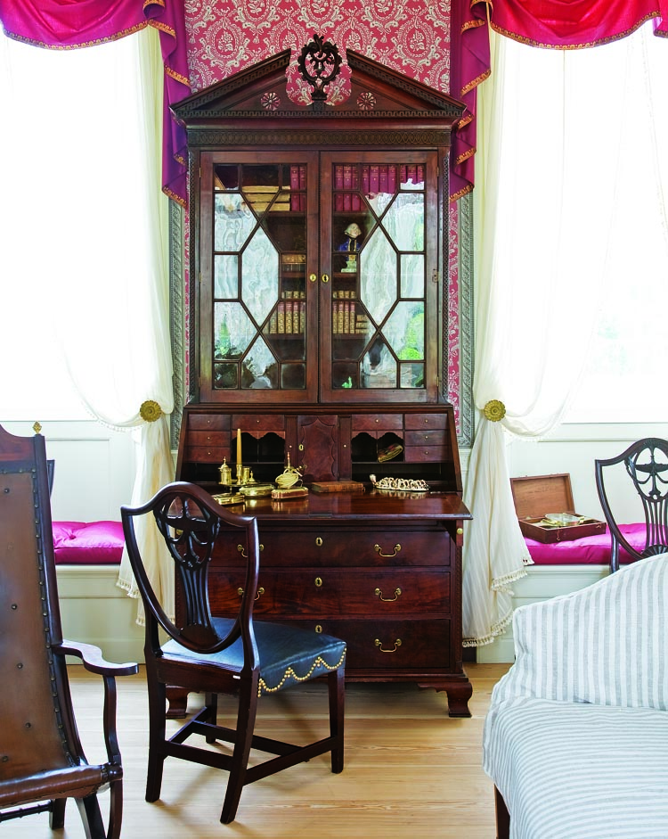 The circa-1780 Pennsylvania mahogany desk and bookcase was once in the ownership of the Dinker family, Eastern Shore, Maryland. The broken-pitch pediment has an applied Greek key fret, oval fret, and applied guilloche fretwork on the corners of both top and bottom, while gadroon molding is applied to the front edge of the right door.