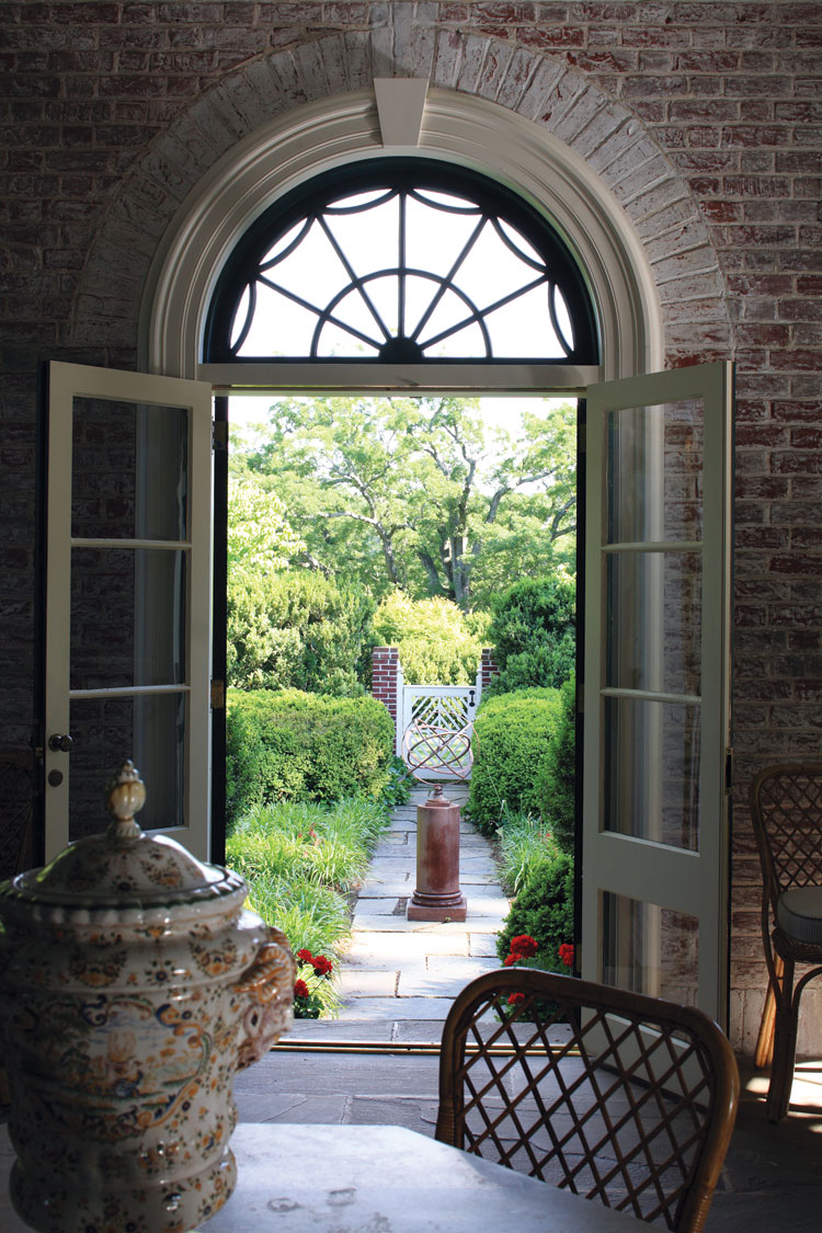 One of the paths in the network of gardens is accessed through the brick enclosed sun porch.