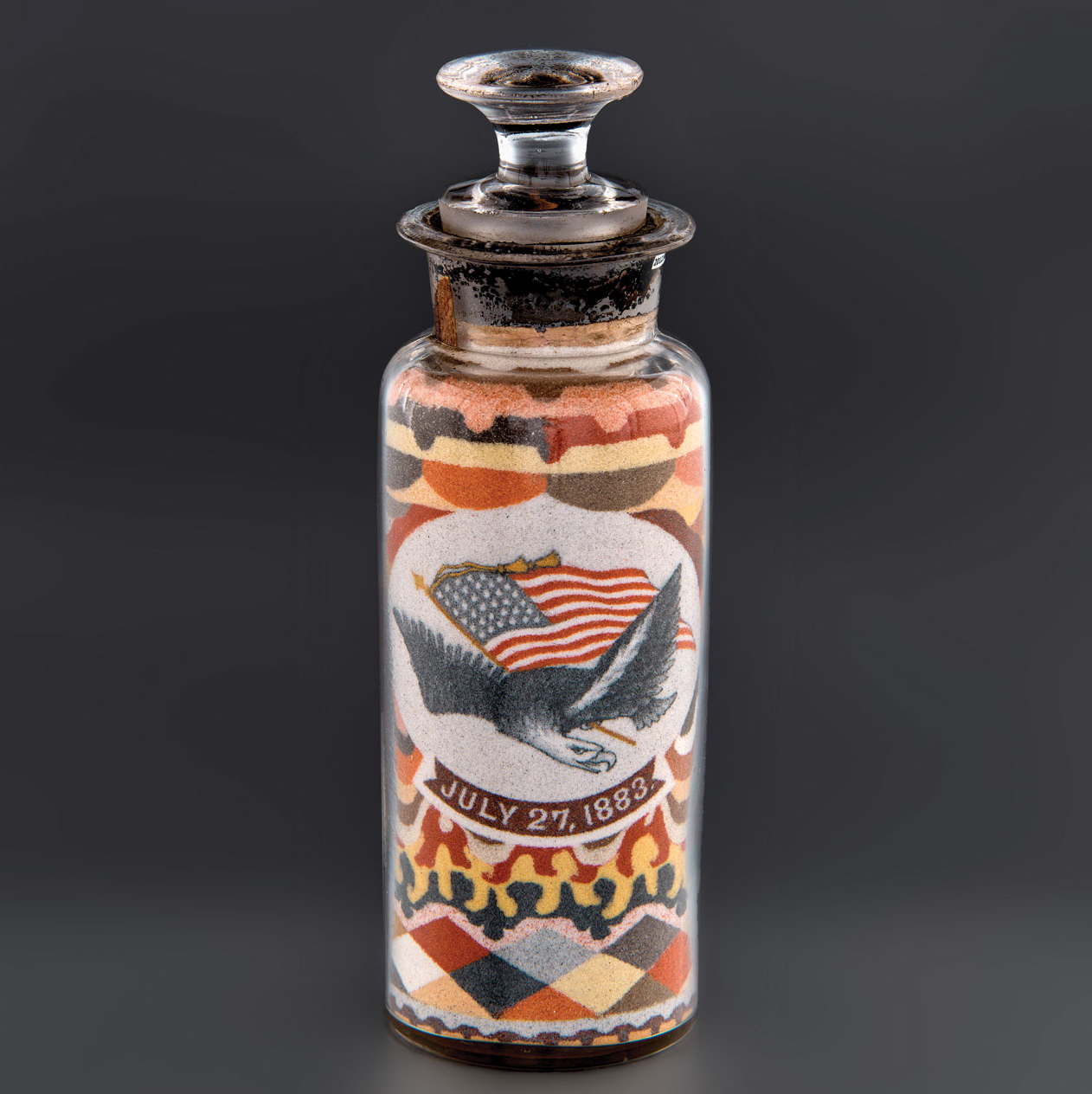 Fig. 7: Sand art bottle made by Andrew Clemens, McGregor, Iowa, 1883. Sand, glass and cork, 7-1/4 x 2 in. Gift of Charles and Doris Flagg (2012.910.1).