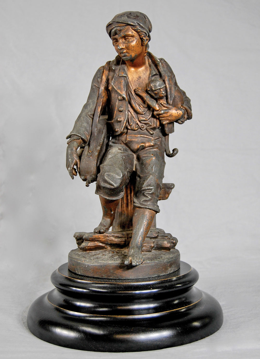 Fig. 13: Hurdy-Gurdy Player, by Cornelius & Baker, Philadelphia, 1855–1869. Bronzed and gilt zinc, wood. H. 13¾ in. Genre figures like this street urchin with his hurdy-gurdy and monkey held great appeal as subject matter for householders during Cornelius & Baker’s heyday. Private collection.