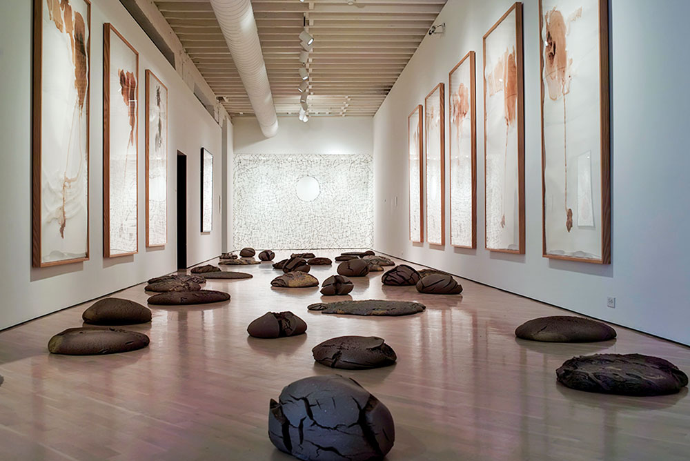 Installation of Andy Goldsworthy’s (United Kingdom, b. 1956) Surface Tension, 1993 (center); Earth and Snow, 1995 (on walls); Rock Pools, 2000 (floor). Photography by Paul Kirschner. The centerpiece of this installation is Surface Tension, which is composed of horse chestnut stalks held together with hawthorn thorns to form a screen suspended between floor, ceiling, and walls.