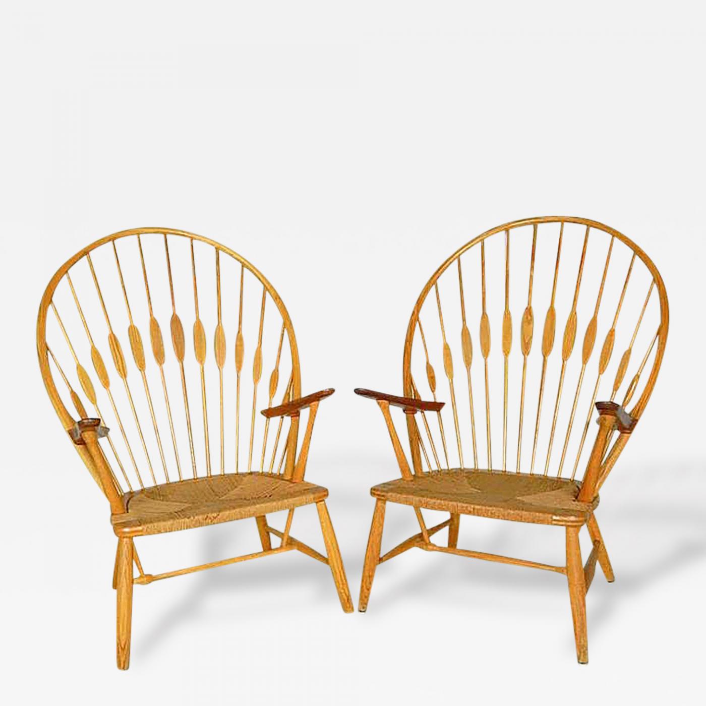 Two Vintage Peacock Chairs by Hans Wegner, circa 1960, model JH550, these chairs were made by Johannes Hansen. Ash, teak and paper cord, signed. Offered by Moderne Gallery.