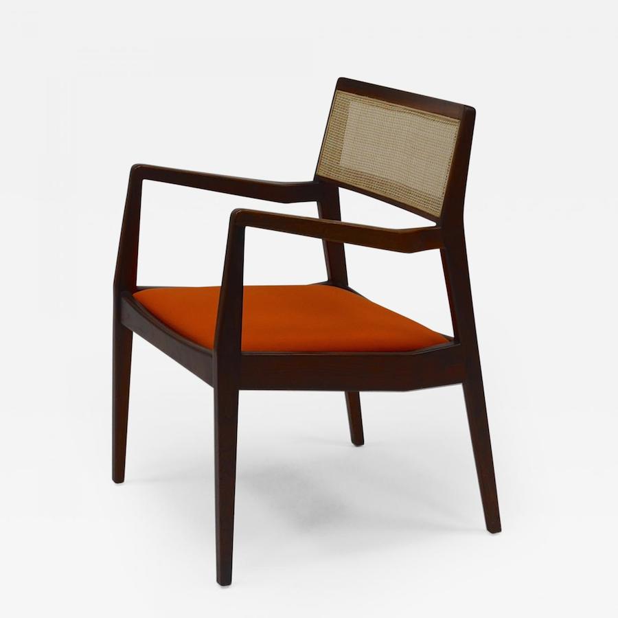 Four Jens Risom “Playboy” C140 chairs in solid black walnut. Classic configuration; upholstered in orange hopsack fabric with recently re-caned backs. A handsome design with tapered legs and curved arms, c. 1960s. Offered by Continuum 20th Century Design.