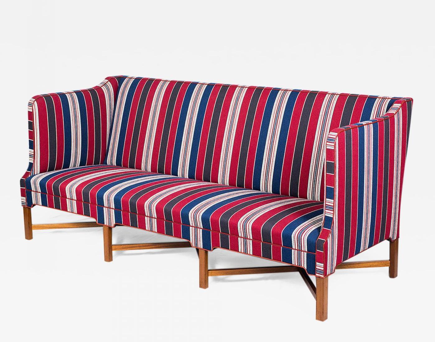 Kaare Klint X-base sofa, Model #4118. Designed in 1930 and produced by Rud Rasmussen, circa 1940s. Wool fabric with red leather piping. Cuban mahogany base. Offered by Denmark 50.