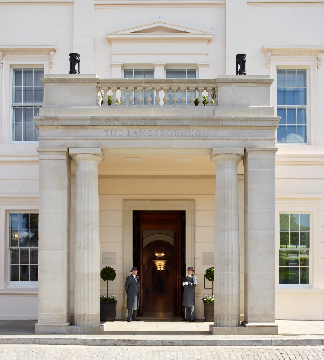 At the entry of the Lanesborough Hotel, doormen stand at the ready.