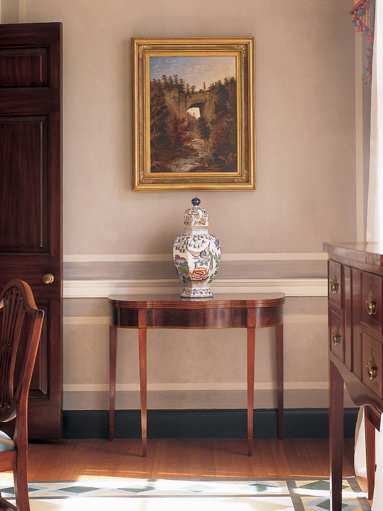 Magazine illustrator and writer David Hunter Strother’s (1816–1888) iconic Natural Bridge was painted in about 1860, at a time when he wrote about the “majestic grandeur” of the Rockbridge County, Virginia, landmark, once owned by Thomas Jefferson. Below the picture is an Annapolis, Maryland, card table.