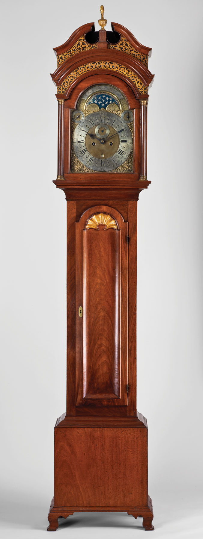 Fig. 7: Tall case clock, casemaker unknown. James Wady, clockmaker, died 1759. Made in Newport, R.I., 1745–1755. Walnut (primary); walnut (blocks behind molding at top of case); maple or birch (runners for hood); maple (seat board); chestnut (back board of hood); yellow poplar (dial mat); pine (blocks on dial mat, bottom board, backboard, rear bracket and block on one rear foot; glue blocks in case). H. 98¼, W. 17, D. 10 in. Movement: 8-day brass time and strike. Marks: “James Wady Newport,” engraved around dial arch. Winterthur Museum, Garden, and Library, Del., Gift of Henry Francis du Pont (1951.0028); (RIF2303).