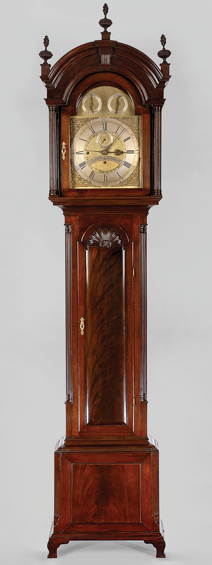 Fig. 8: Tall case clock, casemaker unknown. Thomas Claggett, clockmaker, ca. 1730–1797. Made in Newport, R.I., ca. 1775. Mahogany (primary); white pine (front corner blocks in waist and backboard). H. (with finials) 94, W. 22¼, D. 11 in. Movement: 8-day brass three-train musical and quarter chiming. Marks: “Thomas Clagget Newport,” engraved on an arched nameplate below central arbor on the composite brass dial. Private collection. (RIF5415).