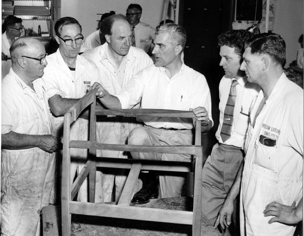 Jens Risom describing his design to colleagues. Image courtesy of the Risom Family Archives.