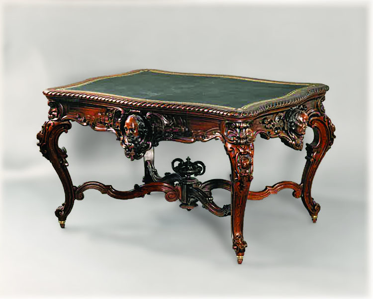 Fig. 7: Library table, Boston, Massachusetts, ca. 1860. Black walnut; H. 30½, W. 57, D. 42 in. Private collection. Owned by Justin Winsor (1831–1897), the eminent librarian of the Boston Public Library and later Harvard College. The carved faces on the rails depict William Shakespeare, Benjamin Franklin, George Washington, and Daniel Webster.