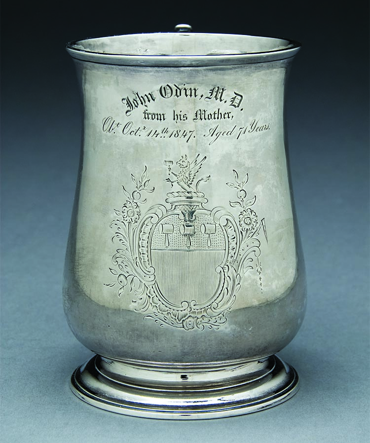 Fig. 7: Cann, by Daniel Henchman (1730–1775), Boston, Mass., ca. 1770. Engraved with Lynde coat of arms: three mallets in chief, crest, a griffin holding a mallet, and also later engraved, “John Odin, M. D. / from his Mother, / Obt. Oct. 14th 1847. Aged 71 Years.” (Dr. John Odin’s (1808–1864) great-grandfather was Judge Benjamin Lynde.) Silver. Overall: 5 x 5¼ x 3⅝ inches. Gift of Steve and Ann W. Lord (2012.17). Historic Deerfield, Inc., Deerfield, Mass. Photography by Penny Leveritt.