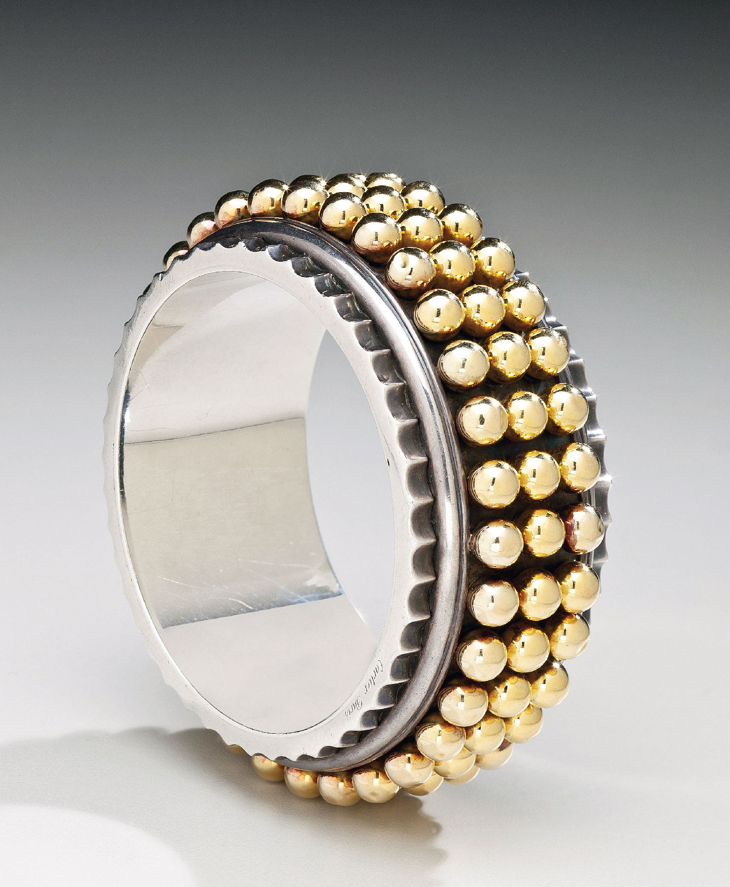 Fig. 12: Bangle bracelet, Cartier, Paris, France, ca. 1930. Silver, gold; Diam: 3½ inches. Purchase 2015; Helen McMahon Brady Cutting Fund (2015.1.1).