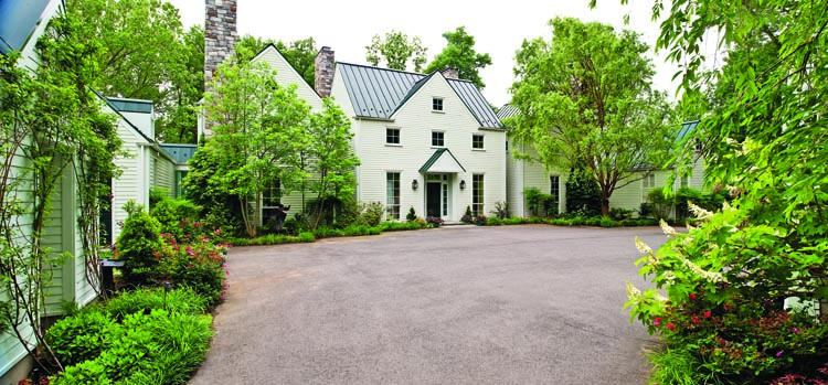“We asked the architect,” says the wife, “for a design that would take advantage of the site of the house, which is secluded and wooded.” To accomplish this, Washington, D. C., architect Jack McCartney used floor-to-ceiling glass connectors with small gardens outside, between five connected buildings, symmetrically placed and surrounded by trees.